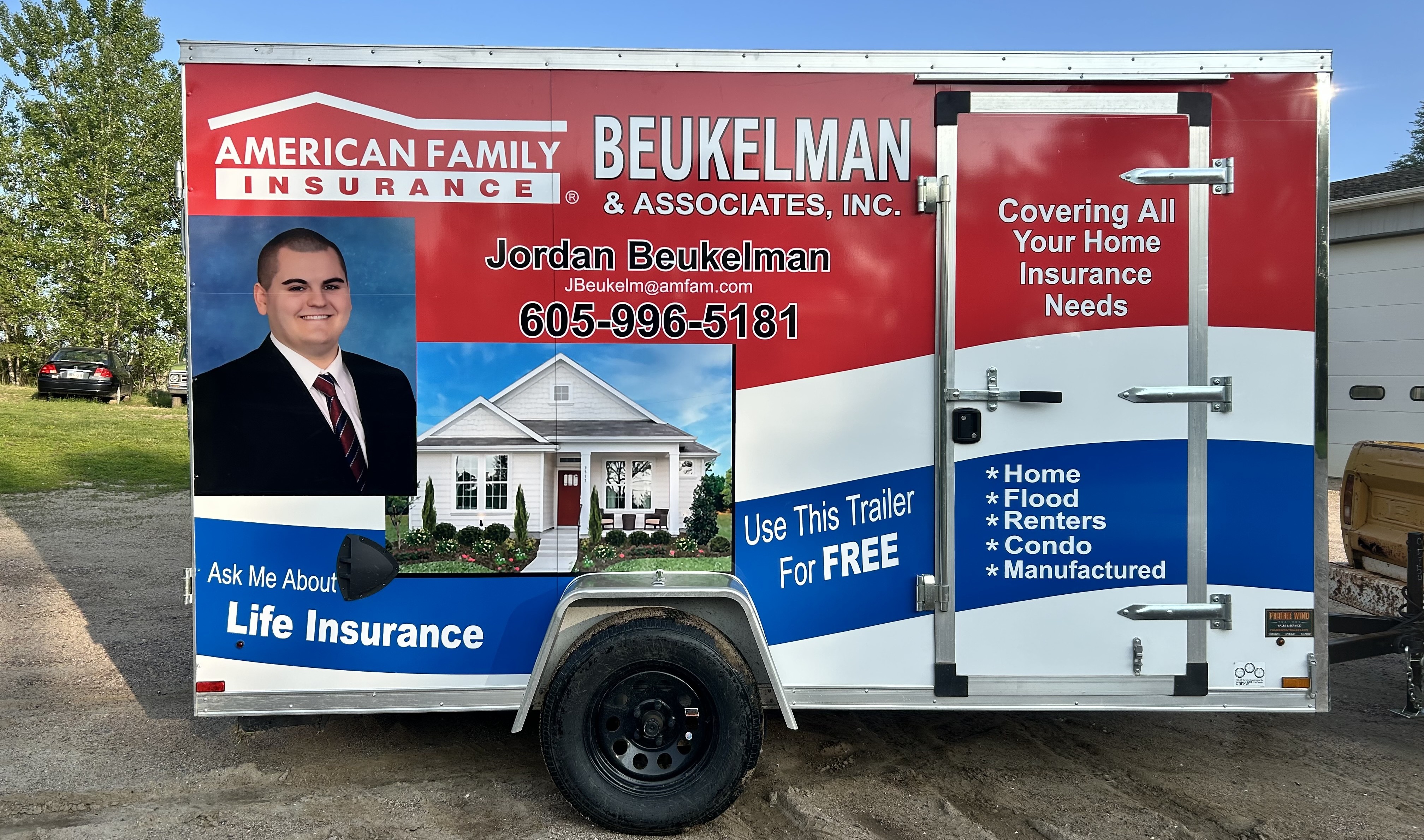 Lettered insurance trailer showing custom sign and branding work